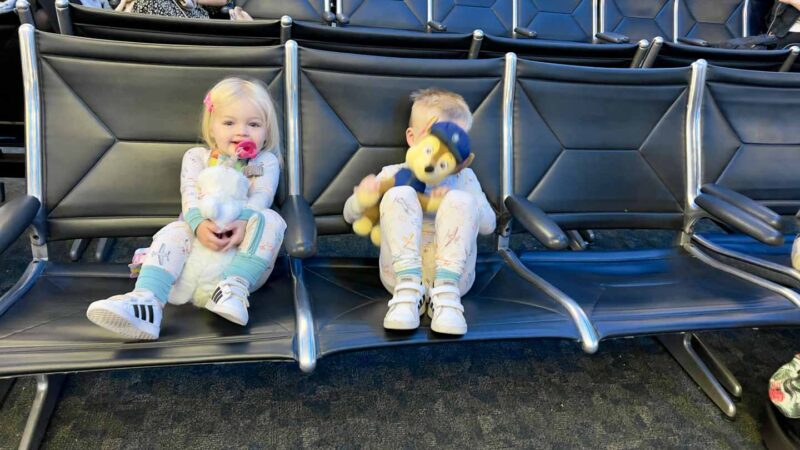 family traveling with kids at the airport at the gate 