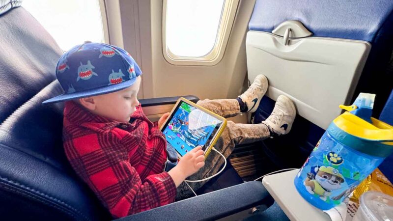 flying with a toddler boy with iPad on an airplane