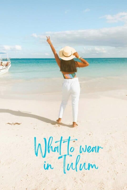 woman on the beach in Tulum with hands in the area