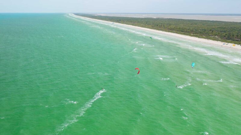 Kite Surfers in the green colored waters of El Cuyo Mexico