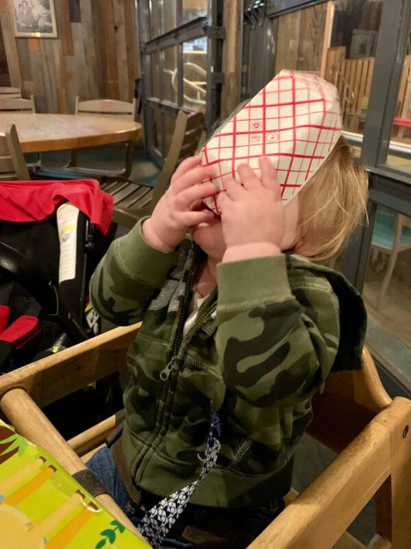 toddler with fry basket on his face