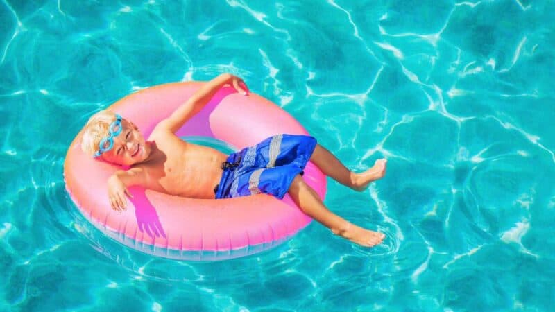 boy in a pool float at hotel