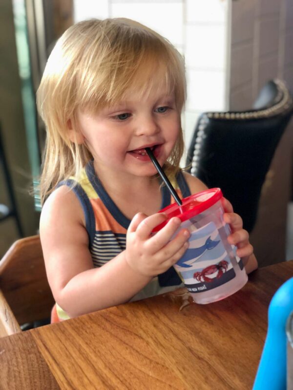 Toddler at restaurants drinking from a cup