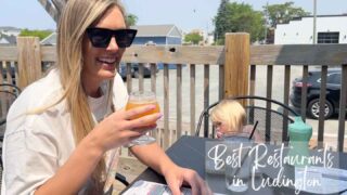 woman holding a beer outside at one of the best restaurants in Ludington Michigan