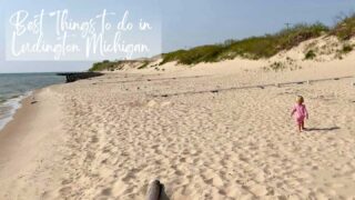 things to do in Ludington Michigan feature image little girl on the sandy beach