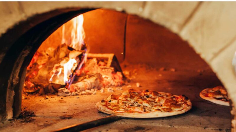 wood fire pizza oven with a pizza at an Italian restaurant