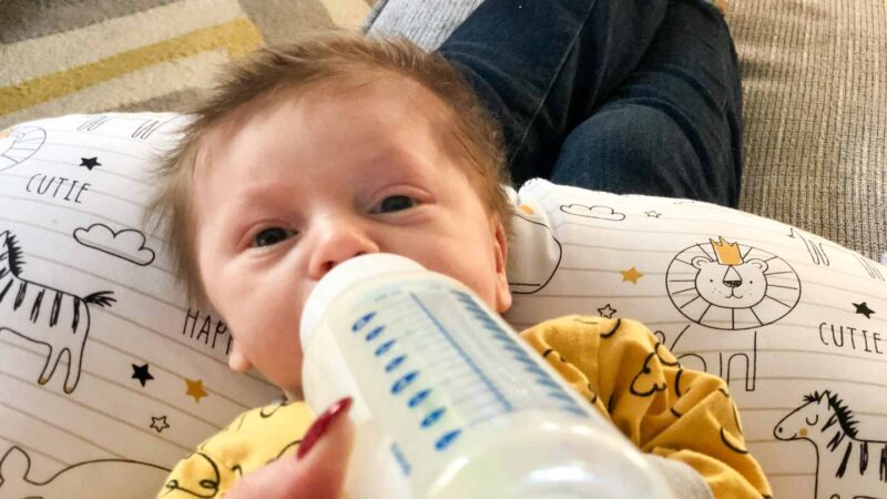 newborn baby boy drinking a bottle