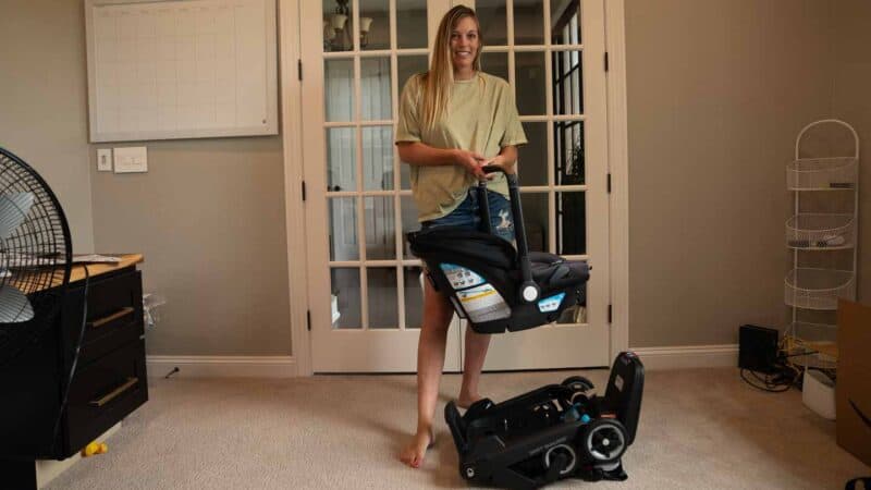 mom holding the Evenflo Shyft DualRide infant car seat 