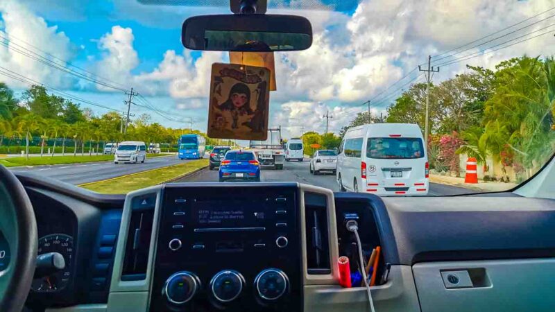 view from inside a Cancun Airport Transportation shuttle traffic on highway