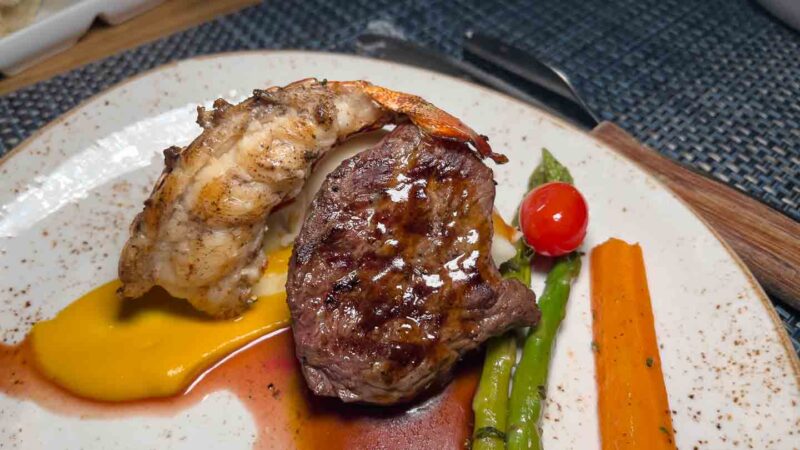 Surf and Turf (steak and lobster) on a plate at Stewfish a Beaches Resort restaurant 