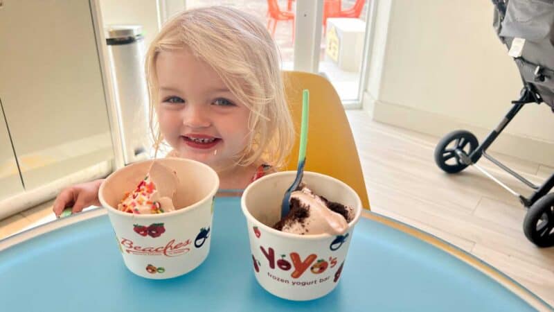 toddler girl eating frozen yogurt at YoYo's in Negril Jamaica.