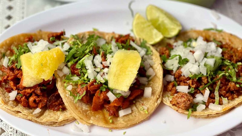 Al pastor tacos and chorizo tacos on a plate