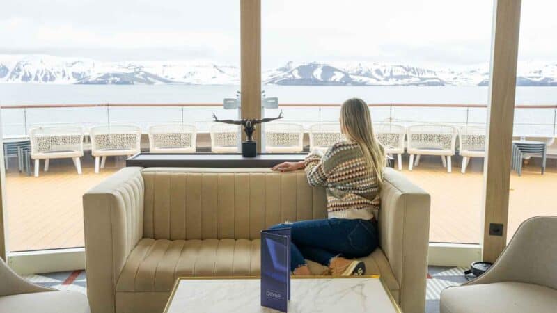 What to wear in Antarctica packing list - woman sitting  looking out the window