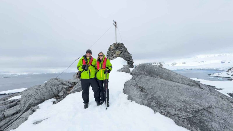 Couple standing on Antarctica - example of what to wear in Antarctica landing day