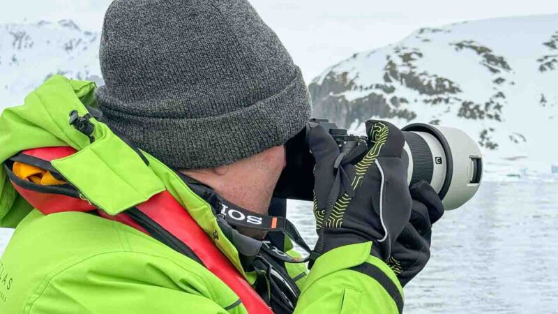 Man taking a photo with camera gear in Antarctica