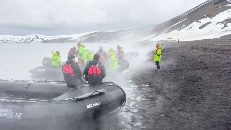 zodiac boot landing at Deception Island passengers with waterproof boots for Antarctica on
