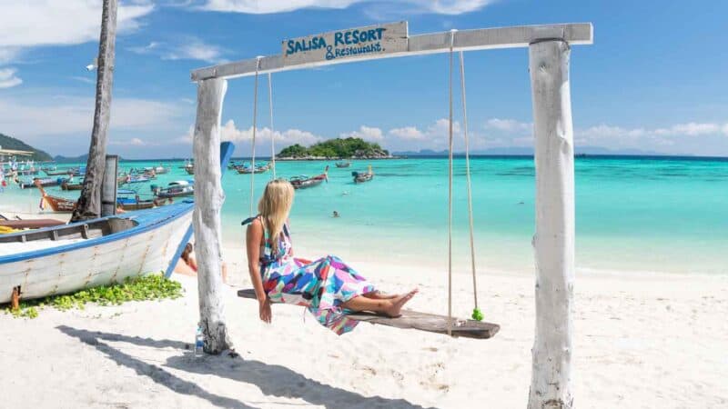 woman on a swing at Salisa Resort on Sunrise Beach in Koh Lipe