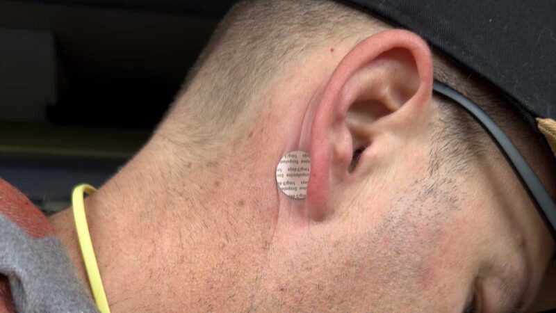 man wearing Scopolamine patch seasickness patch behind ear