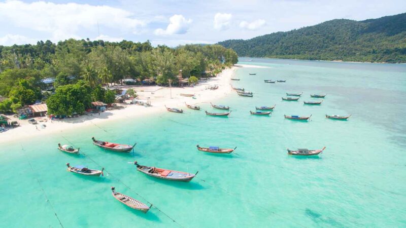 Sunrise Beach Koh Lipe Thailand with boats floating in the turquoise waters and white sandy beach