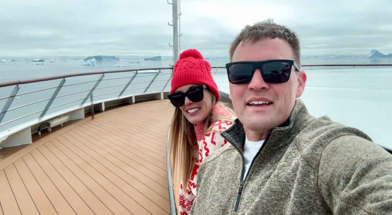 couple on the deck of Antarctica cruise ship without coats