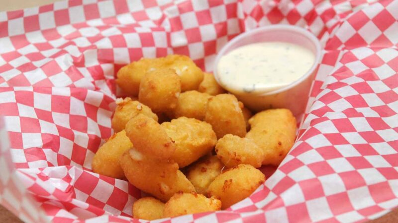 the best cheese curds in Milwaukee in a basket with ranch 