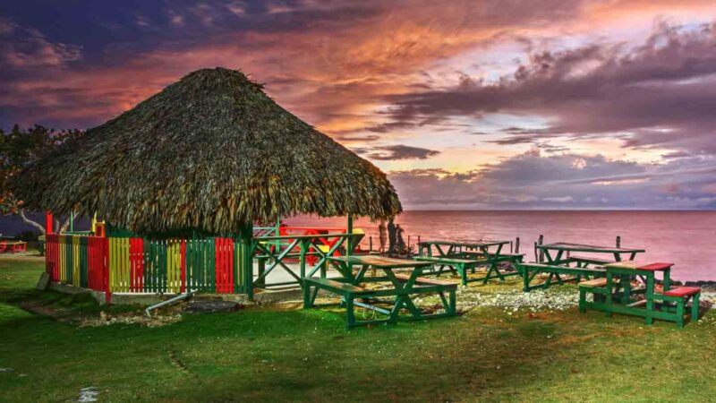 Three Dives Jerk Chicken Restaurant and Bar in Jamaica on the cliffs at sunset